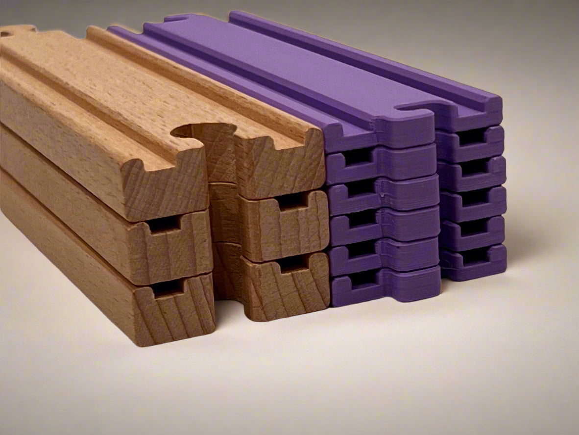 3 Wooden train tracks stacked next to 6 HexTracks. They are the same height.